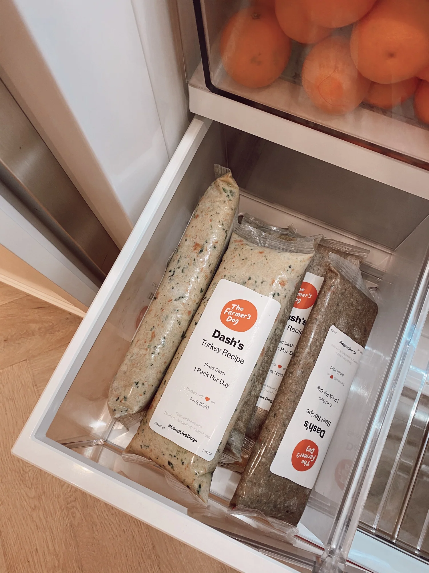 Frozen packs of The Farmer's Dog Dash's turkey and beef recipes stored in refrigerator drawer