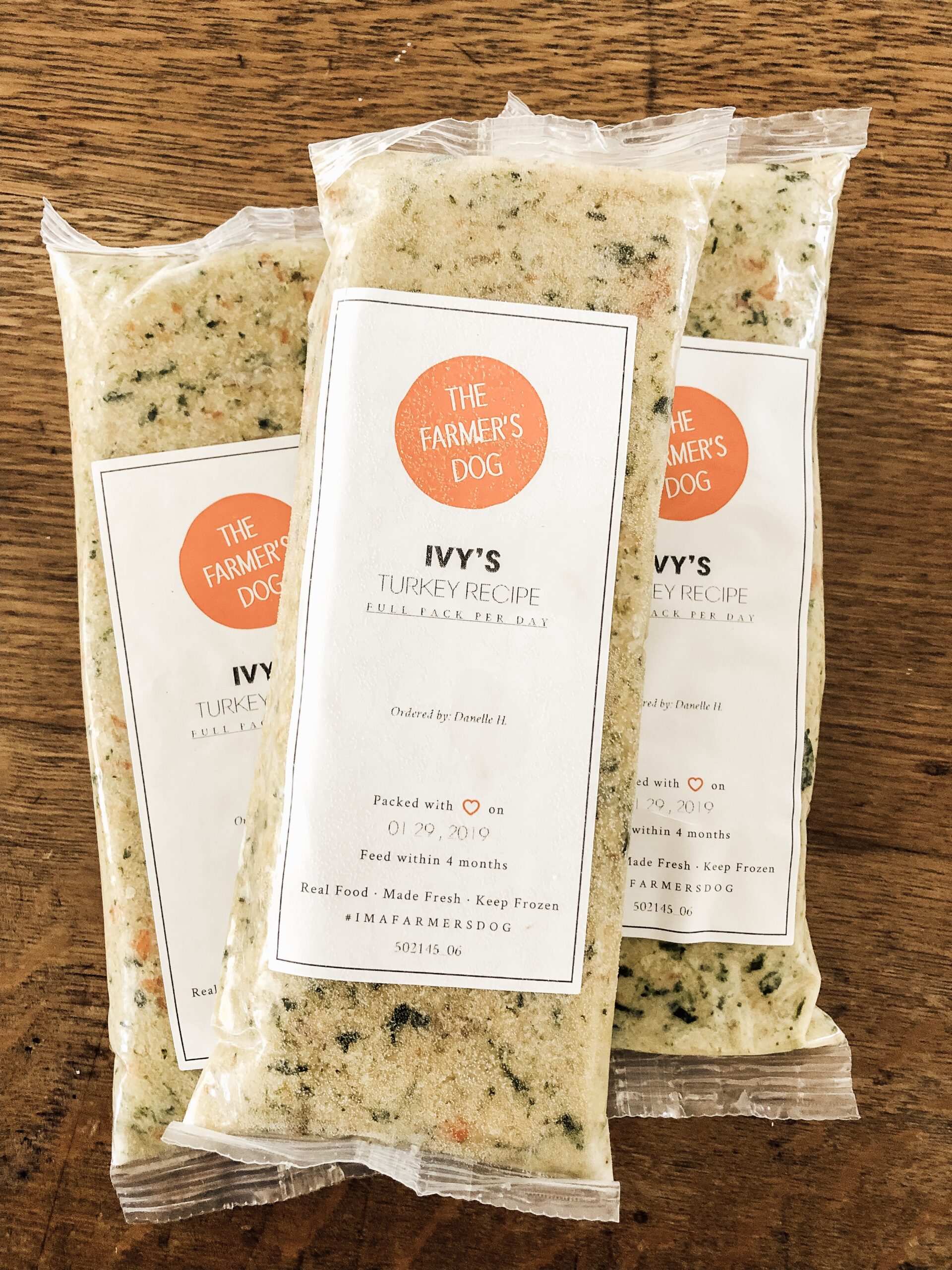 Three packs of The Farmer's Dog Ivy's turkey recipe placed on a wooden table